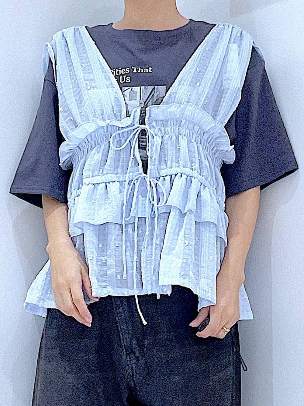 ブラック系のデニムパンツ、グレー系のTシャツ/カットソー、ブルー系のベストを着用したレディースの夏コーディネートの7枚目の写真