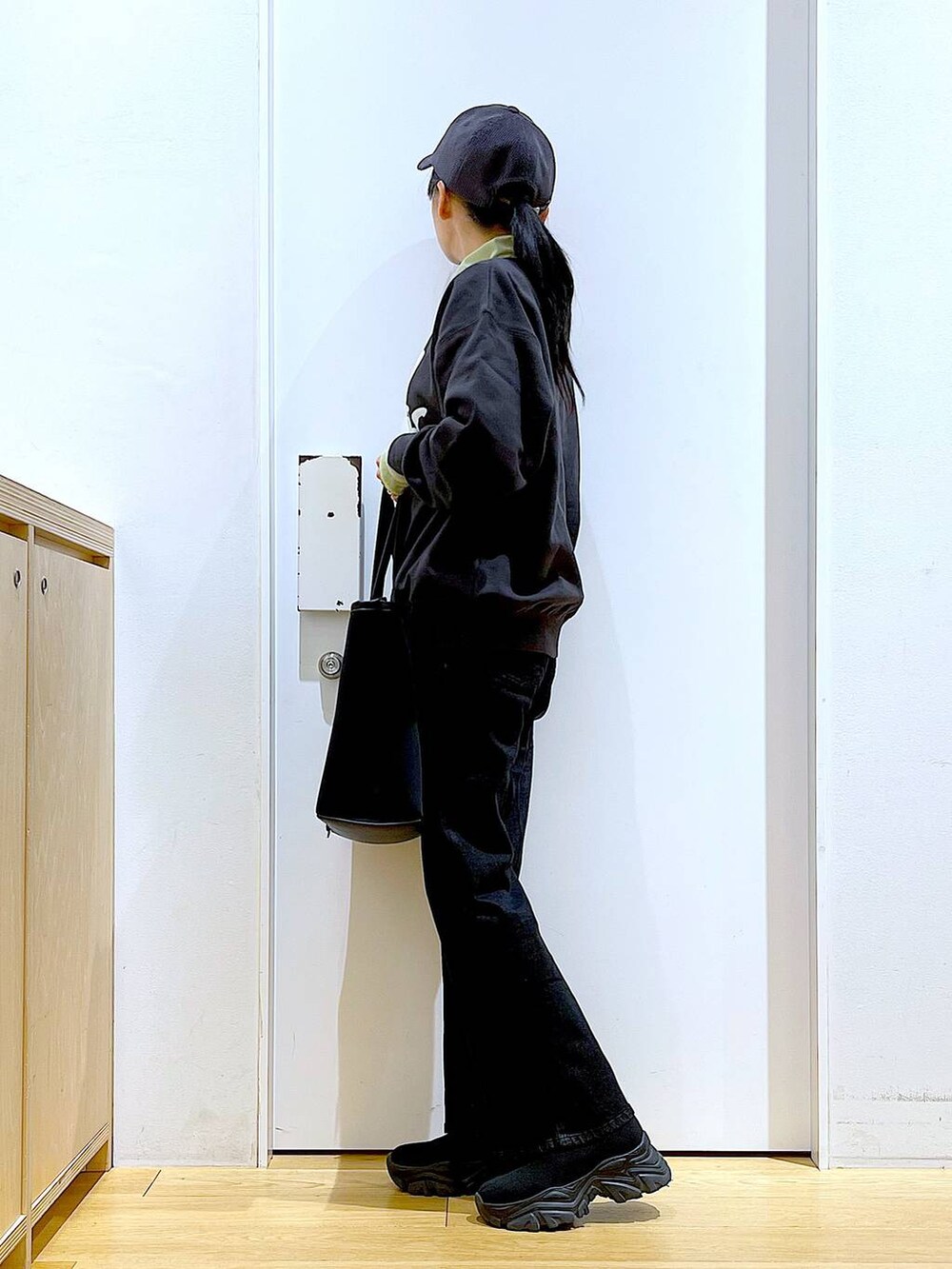 グレー系のデニムパンツ、グレー系のスウェット、グリーン系のその他トップスを着用したレディースの冬コーディネートの3枚目の写真