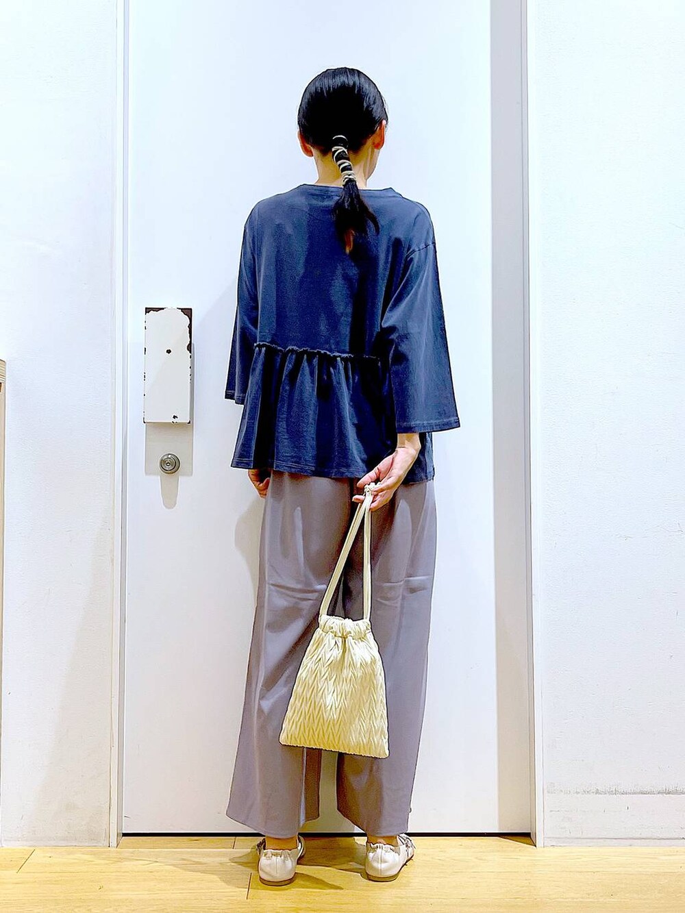 ホワイト系のショルダーバッグ、グレー系のその他パンツ、ホワイト系のパンプスを着用したレディースの秋コーディネートの5枚目の写真