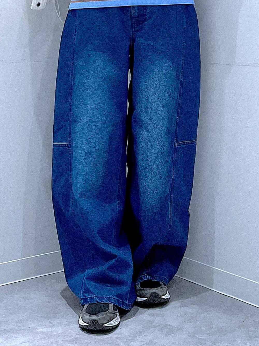 ブルー系のニット/セーター、ブルー系のデニムパンツ、ベージュ系のブルゾンを着用したレディースの冬コーディネートの8枚目の写真