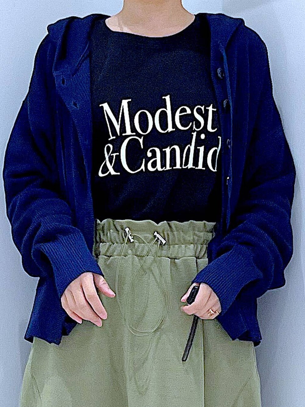 ブラック系のTシャツ/カットソー、ブラック系のショルダーバッグ、グリーン系のスカートを着用したレディースの春コーディネートの7枚目の写真