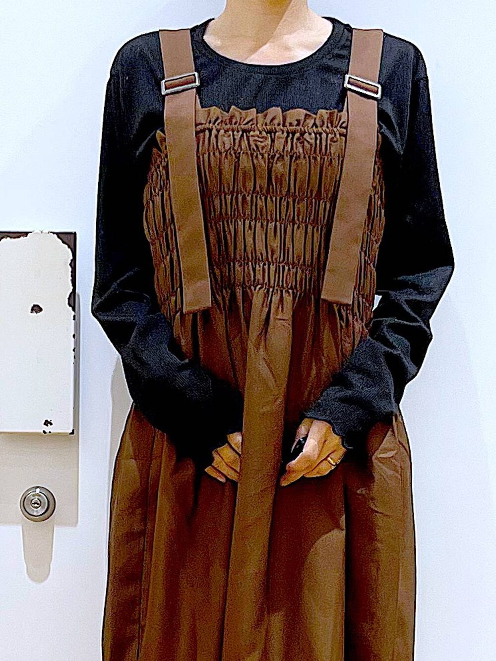 ブラック系のブーツ、ブラウン系のワンピース、ブラック系のショルダーバッグを着用したレディースの冬コーディネートの7枚目の写真