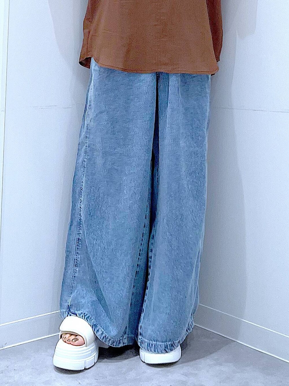グレー系のショルダーバッグ、ホワイト系のサンダル、ブルー系のデニムパンツを着用したレディースの夏コーディネートの8枚目の写真