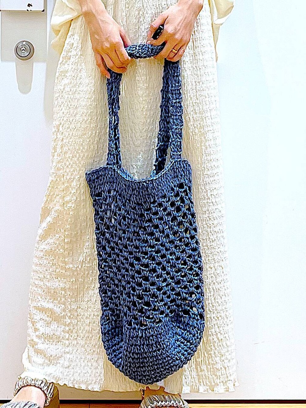 シルバー系のサンダル、ブルー系のトートバッグ、ベージュ系のスカートを着用したレディースの夏コーディネートの9枚目の写真