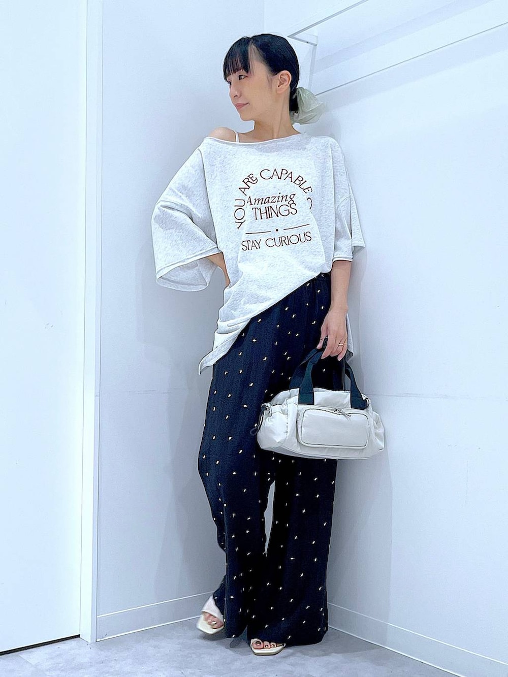 ホワイト系のサンダル、ホワイト系のショルダーバッグ、グレー系のTシャツ/カットソーを着用したレディースの夏コーディネートの2枚目の写真