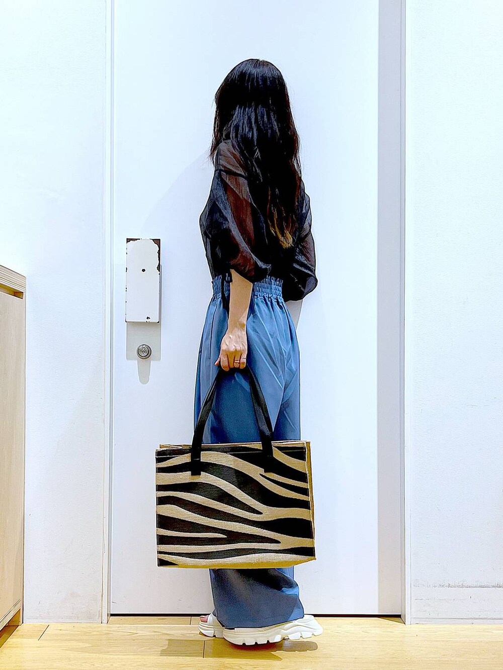 ホワイト系のサンダル、その他のトートバッグ、ブルー系のその他パンツを着用したレディースの夏コーディネートの3枚目の写真