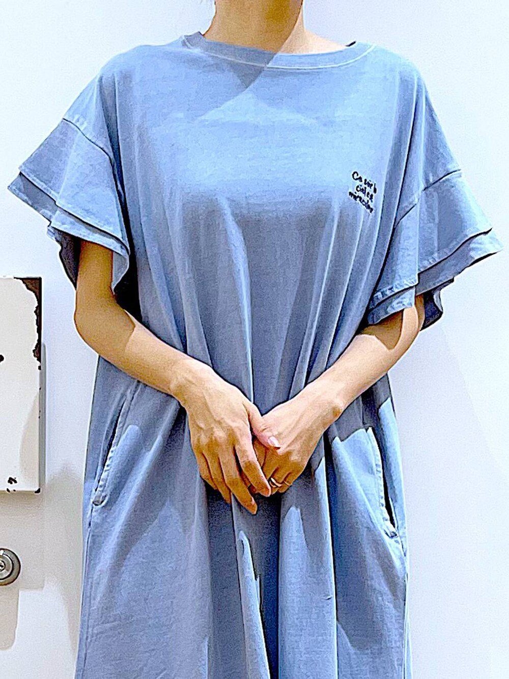 ホワイト系のサンダル、ベージュ系のトートバッグ、ブルー系のワンピースを着用したレディースの夏コーディネートの7枚目の写真