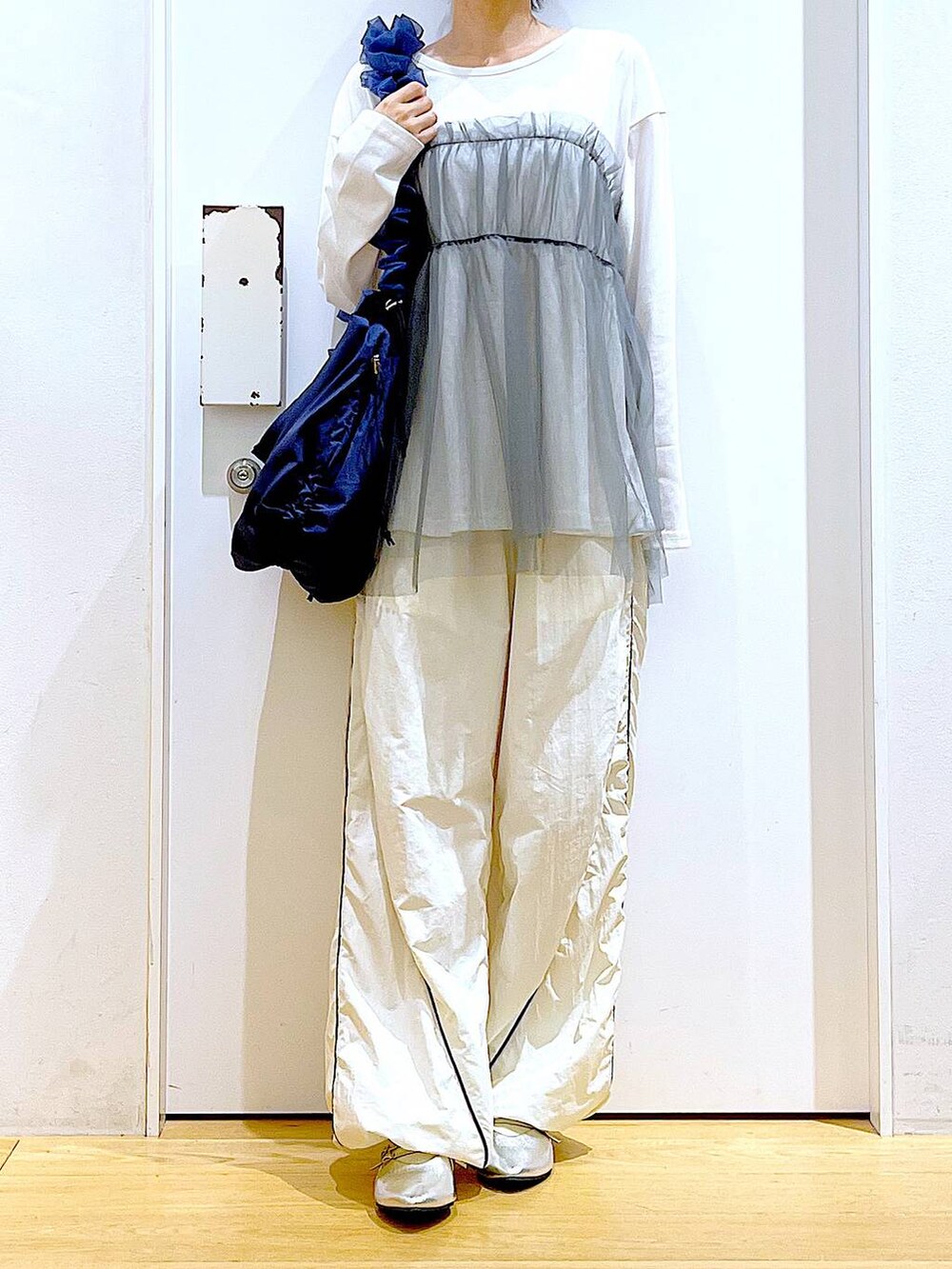 シルバー系のパンプス、ブルー系のショルダーバッグ、グレー系のTシャツ/カットソーを着用したレディースの秋コーディネートの6枚目の写真