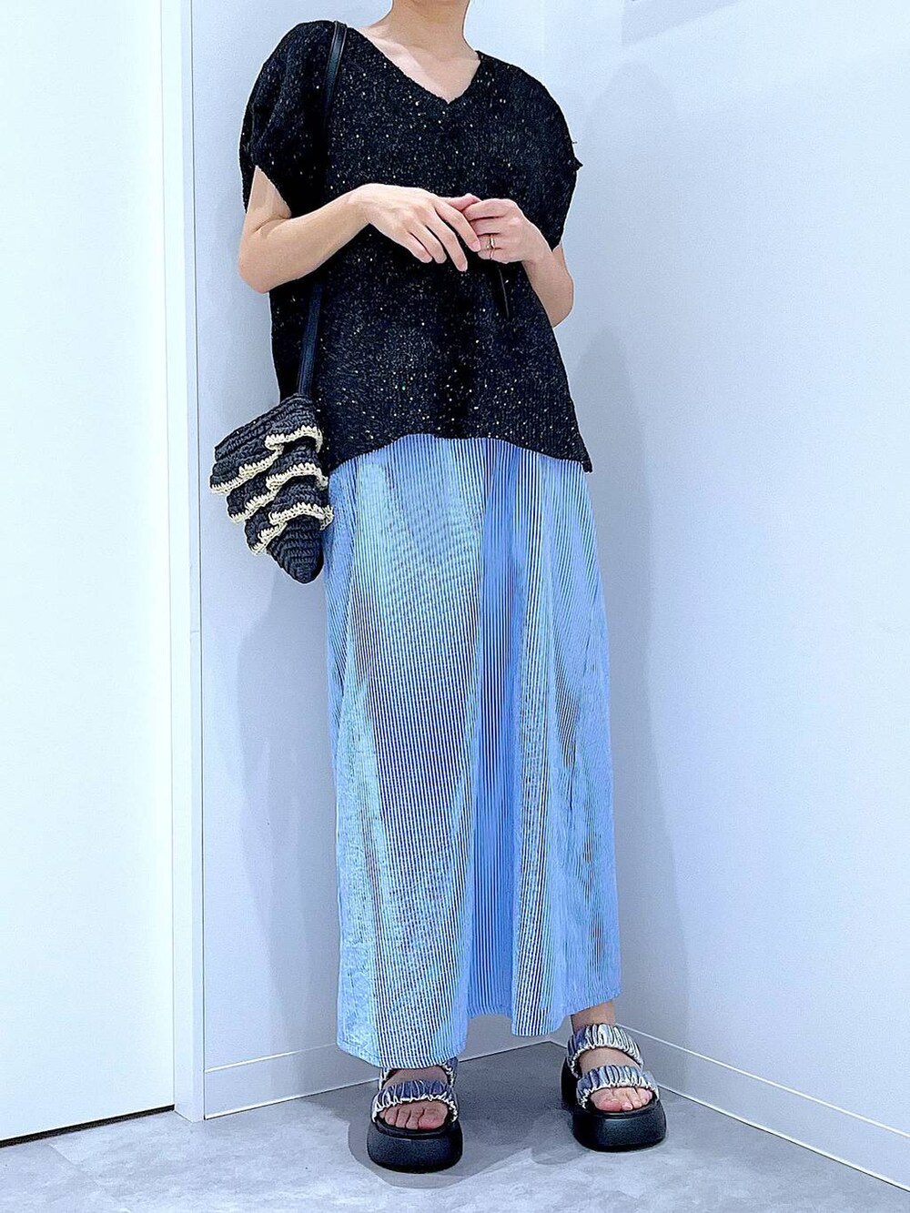 ブラック系のショルダーバッグ、シルバー系のサンダル、ブラック系のベストを着用したレディースの夏コーディネートの6枚目の写真