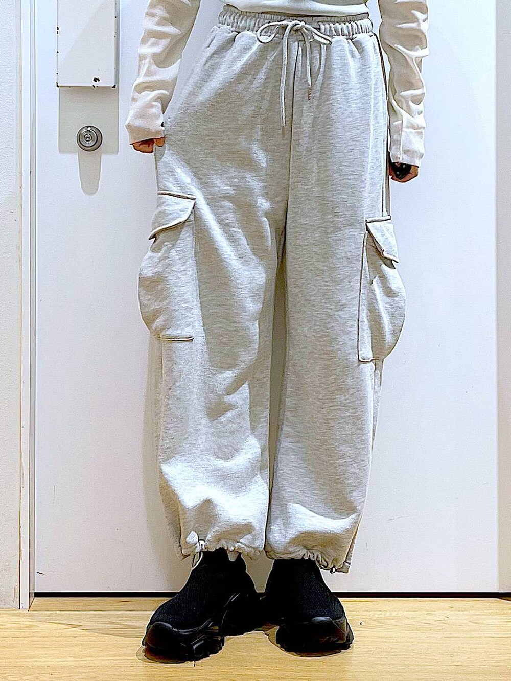 グレー系のスウェットパンツ、ベージュ系のバックパック/リュック、ブラック系のスニーカーを着用したレディースの春コーディネートの8枚目の写真