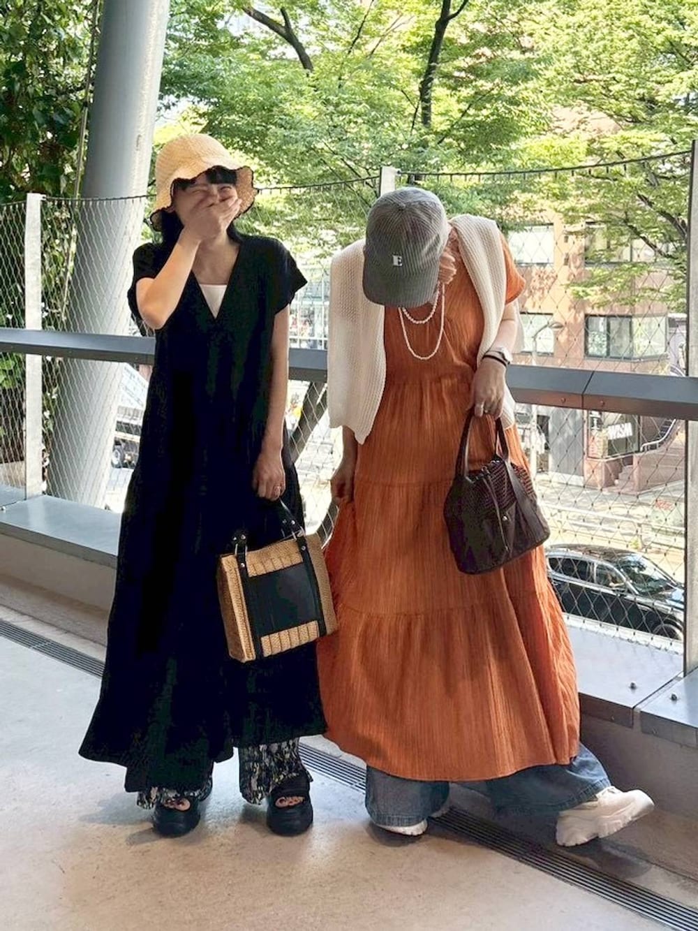 ホワイト系のショルダーバッグ、ブラウン系のショルダーバッグ、ブラック系のサンダルを着用したレディースの春コーディネートの4枚目の写真