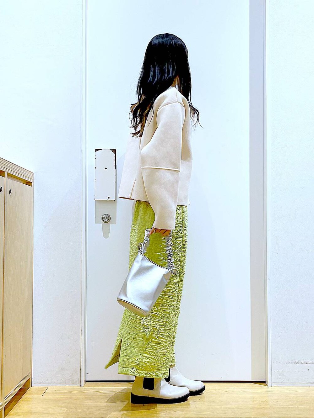 その他のショルダーバッグ、グリーン系のスカート、ベージュ系のブーツを着用したレディースの春コーディネートの4枚目の写真