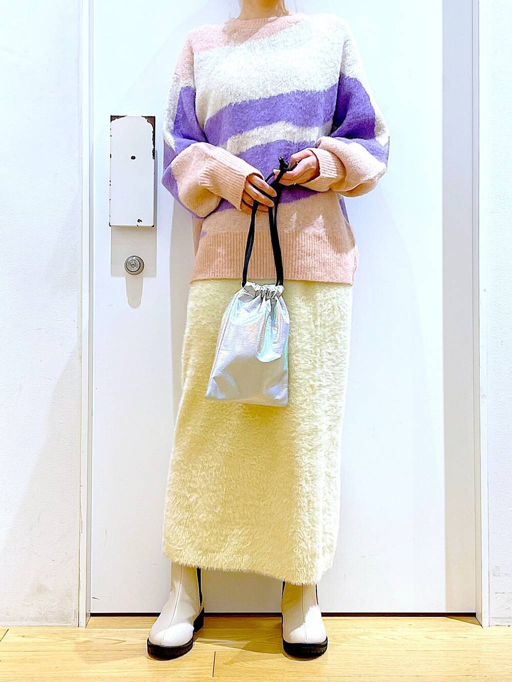 ベージュ系のブーツ、その他のショルダーバッグ、ホワイト系のスカートを着用したレディースの冬コーディネートの6枚目の写真