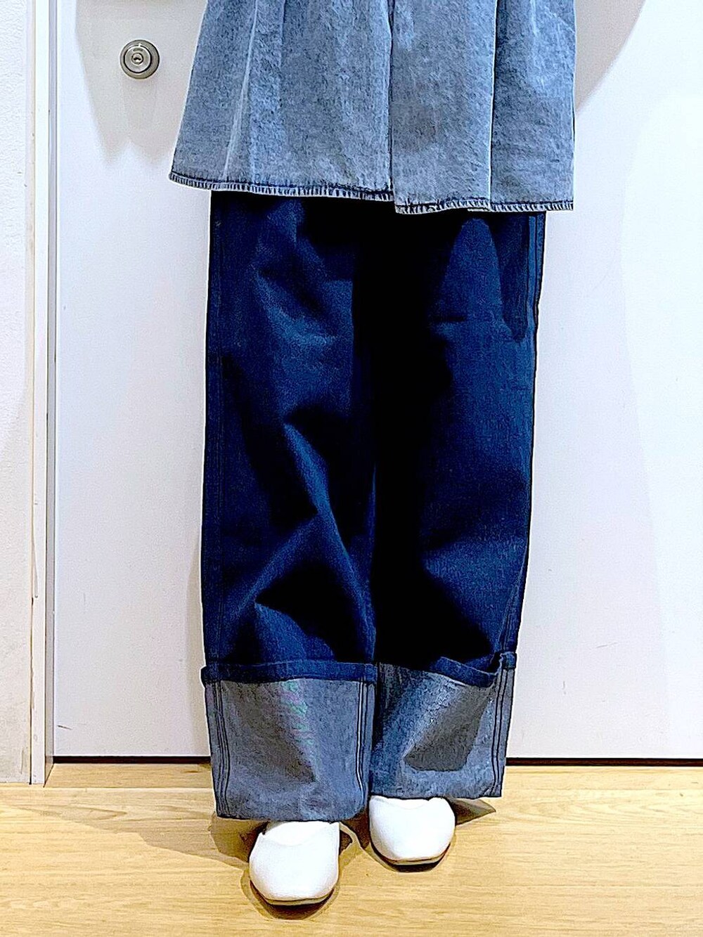 ホワイト系のパンプス、ブルー系のデニムパンツ、ブラック系のショルダーバッグを着用したレディースの春コーディネートの8枚目の写真