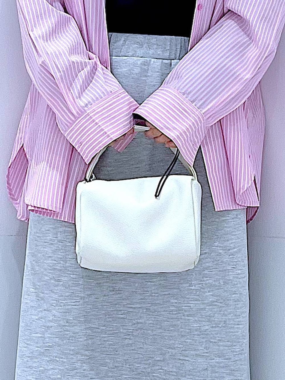 ホワイト系のショルダーバッグ、ブラック系のTシャツ/カットソー、グレー系のスカートを着用したレディースの春コーディネートの9枚目の写真