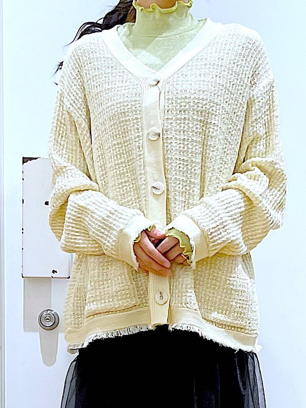 グレー系のショルダーバッグ、ベージュ系のブーツ、ブラック系のスカートを着用したレディースの冬コーディネートの7枚目の写真