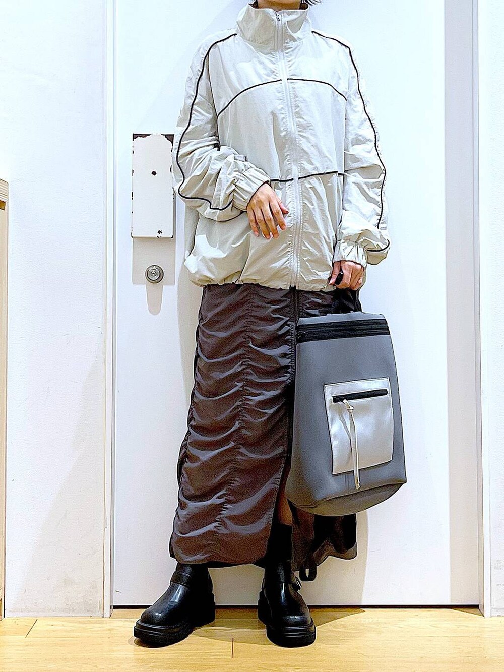 ブラック系のブーツ、グレー系のバックパック/リュック、グレー系のブルゾンを着用したレディースの秋コーディネートの6枚目の写真