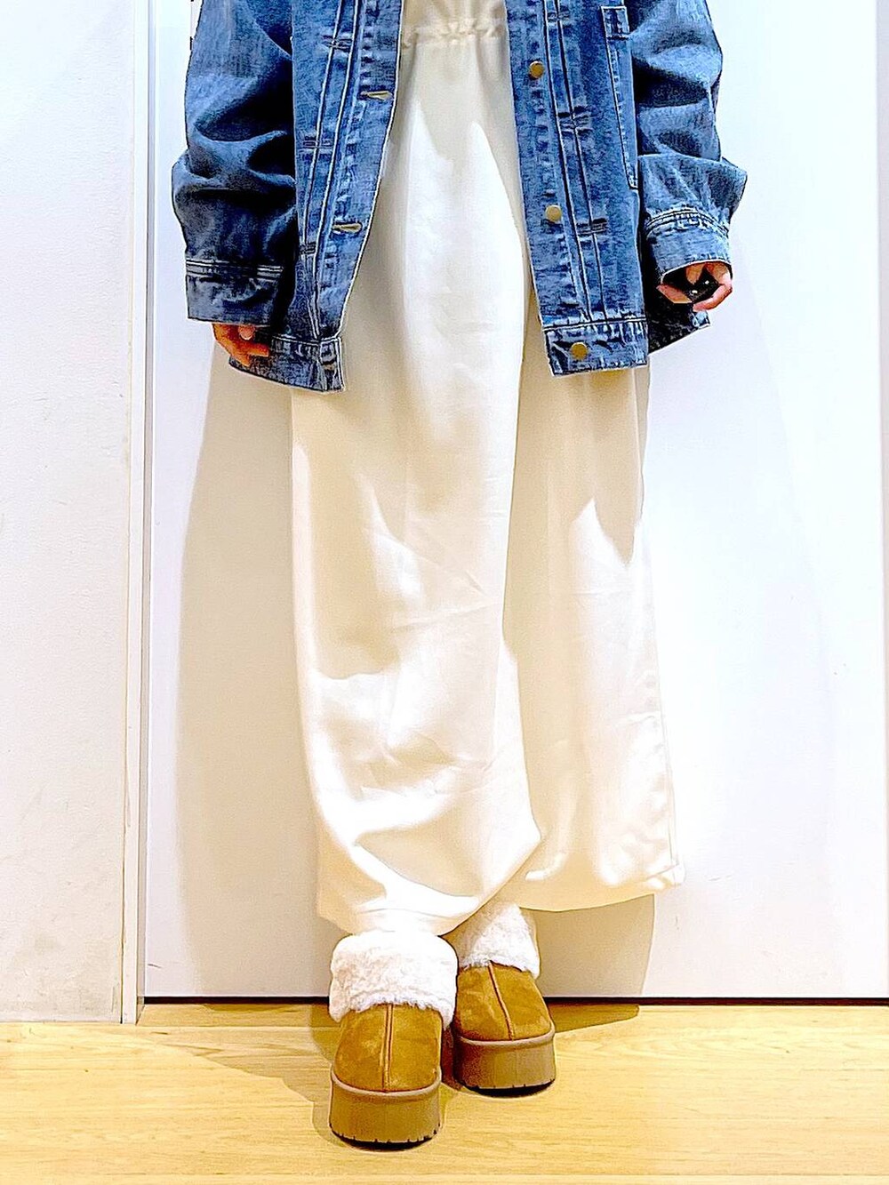 グレー系のショルダーバッグ、ベージュ系のワンピース、ベージュ系のスリッポンを着用したレディースの秋コーディネートの7枚目の写真