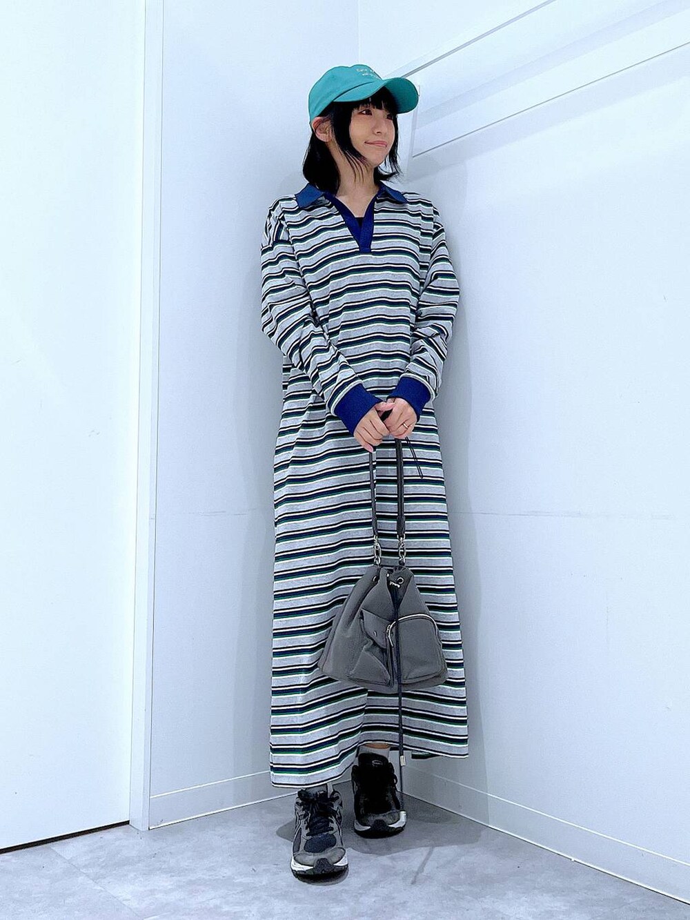 グリーン系のキャップを着用したレディースの春コーディネートの2枚目の写真