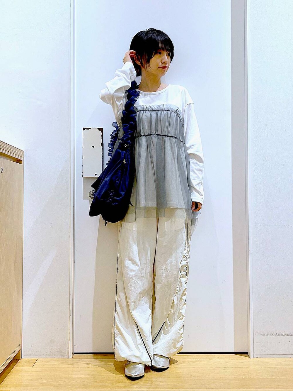 シルバー系のパンプス、ブルー系のショルダーバッグ、グレー系のTシャツ/カットソーを着用したレディースの秋コーディネートの2枚目の写真