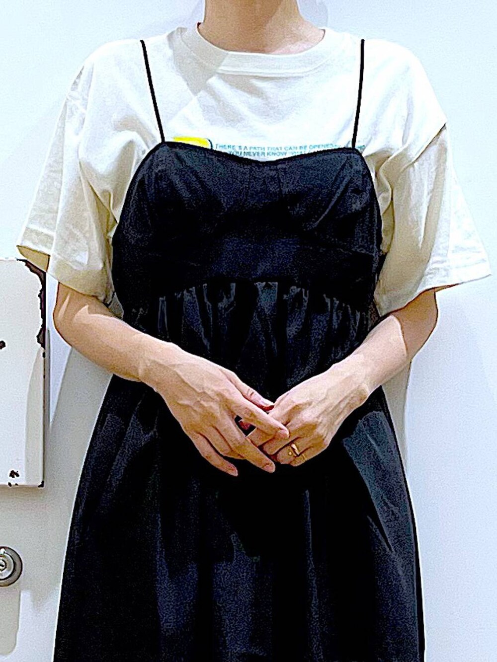 ホワイト系のサンダル、ベージュ系のTシャツ/カットソー、ブラック系のワンピースを着用したレディースの夏コーディネートの8枚目の写真