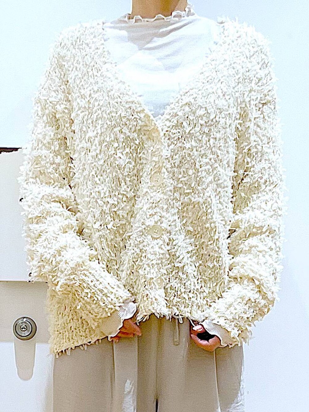 ホワイト系のトートバッグ、ベージュ系のTシャツ/カットソー、シルバー系のパンプスを着用したレディースの冬コーディネートの7枚目の写真