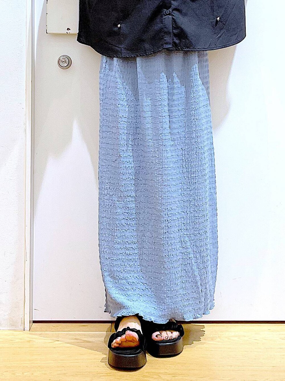 ブラック系のサンダル、ブルー系のスカート、グレー系のショルダーバッグを着用したレディースの秋コーディネートの8枚目の写真