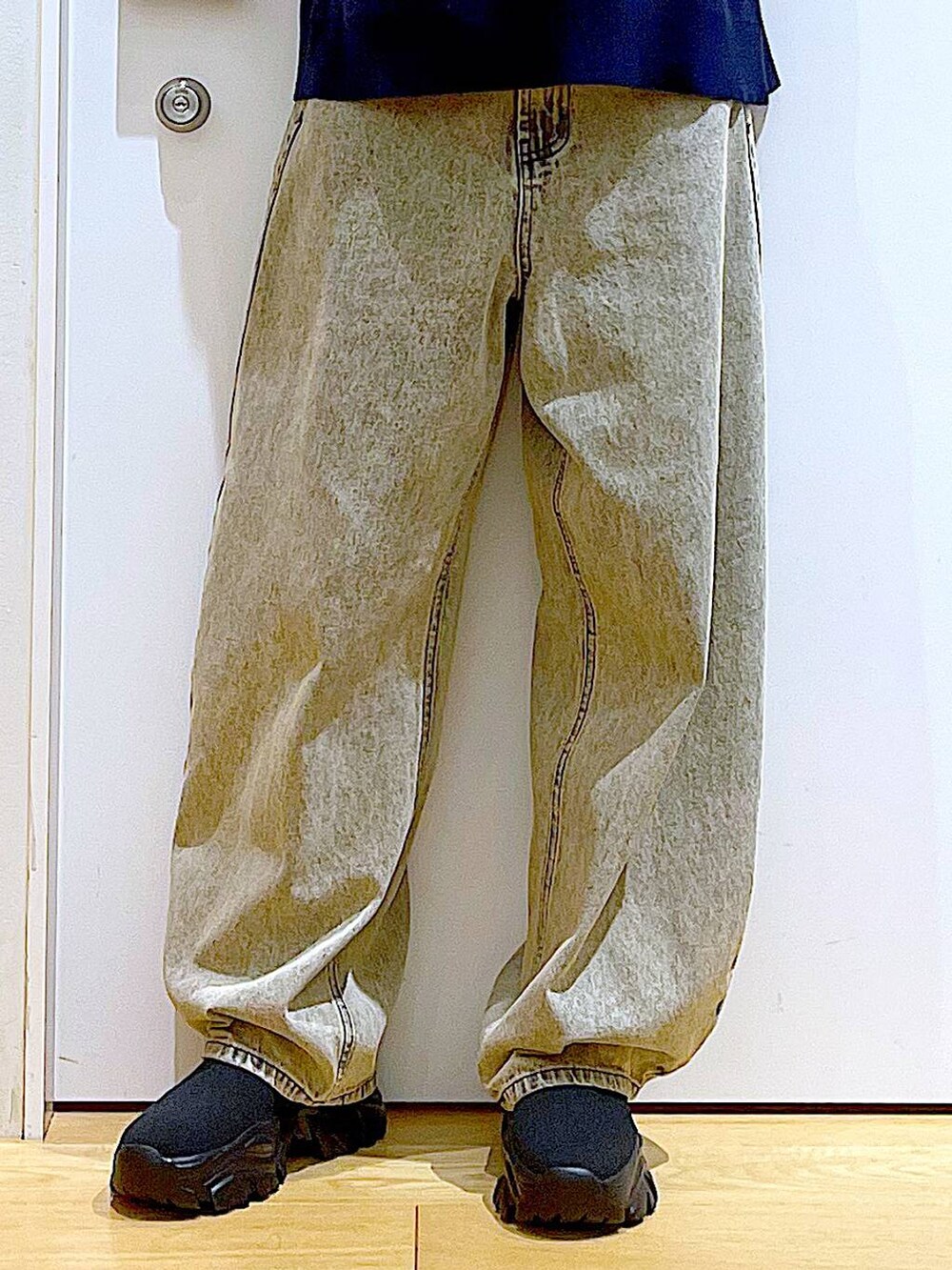 ブラック系のブーツ、ベージュ系のデニムパンツ、イエロー系のトートバッグを着用したレディースの冬コーディネートの8枚目の写真