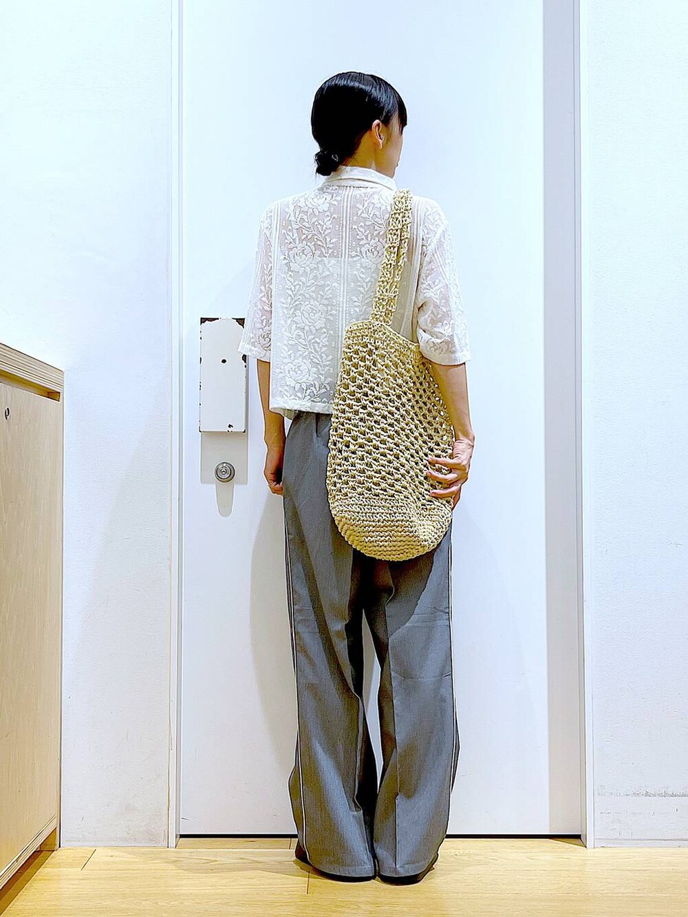 ホワイト系のサンダル、ホワイト系のトートバッグ、ベージュ系のシャツ/ブラウスを着用したレディースの秋コーディネートの5枚目の写真