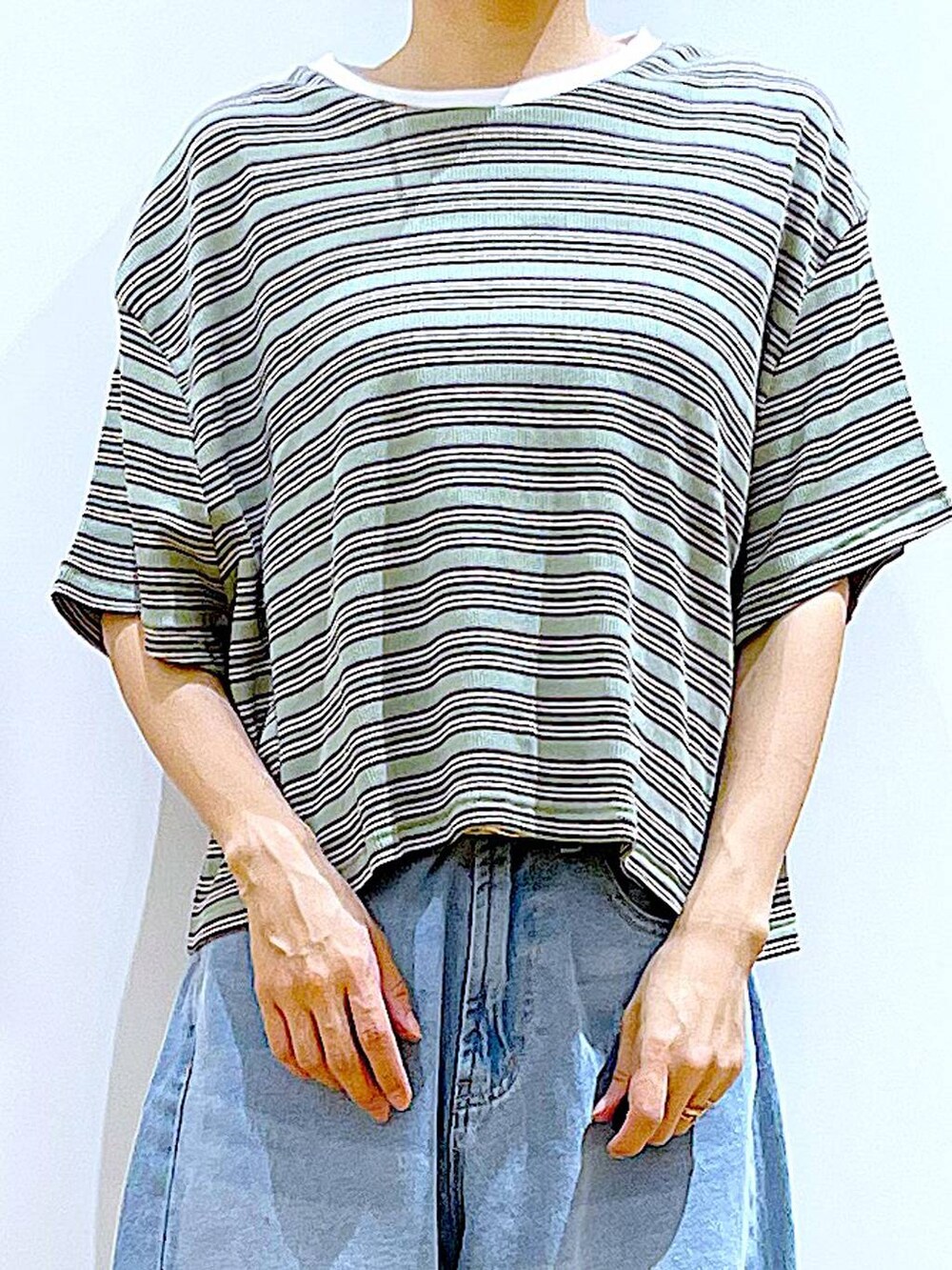 ホワイト系のバックパック/リュック、ホワイト系のサンダル、ブルー系のデニムパンツを着用したレディースの夏コーディネートの7枚目の写真