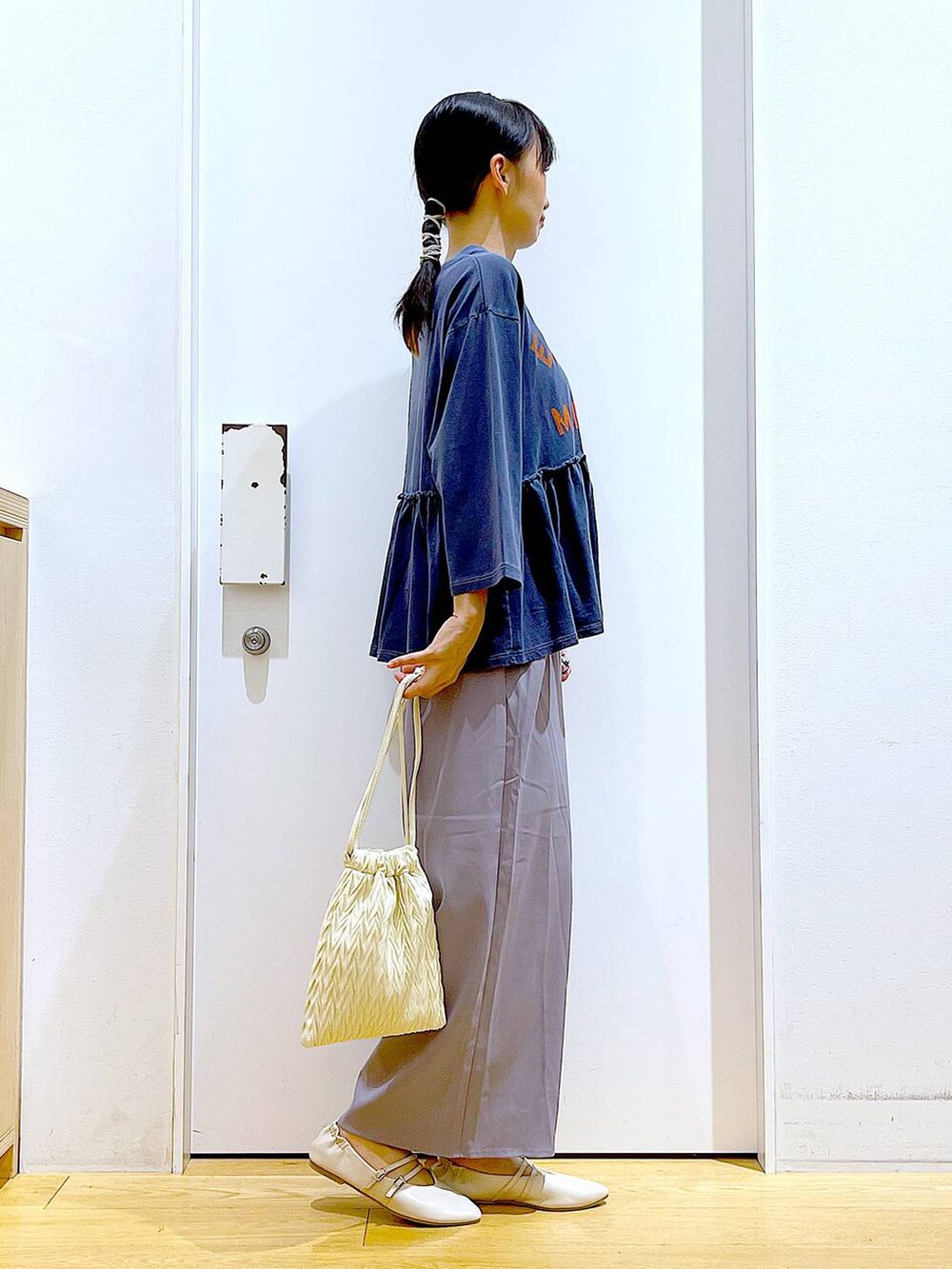 ホワイト系のショルダーバッグ、グレー系のその他パンツ、ホワイト系のパンプスを着用したレディースの秋コーディネートの4枚目の写真