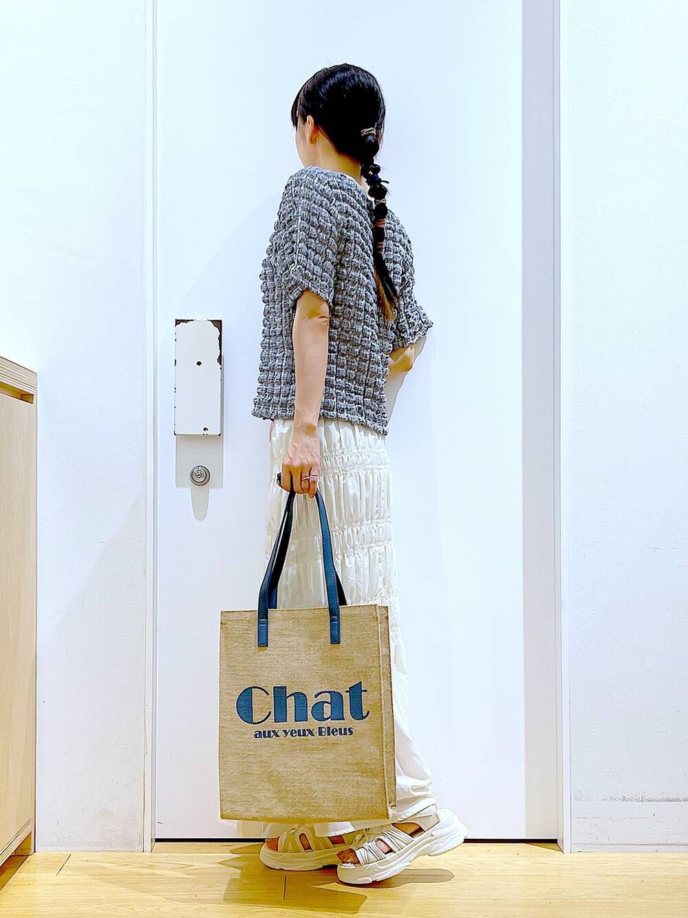 ホワイト系のサンダル、ブルー系のトートバッグ、その他のTシャツ/カットソーを着用したレディースの夏コーディネートの3枚目の写真