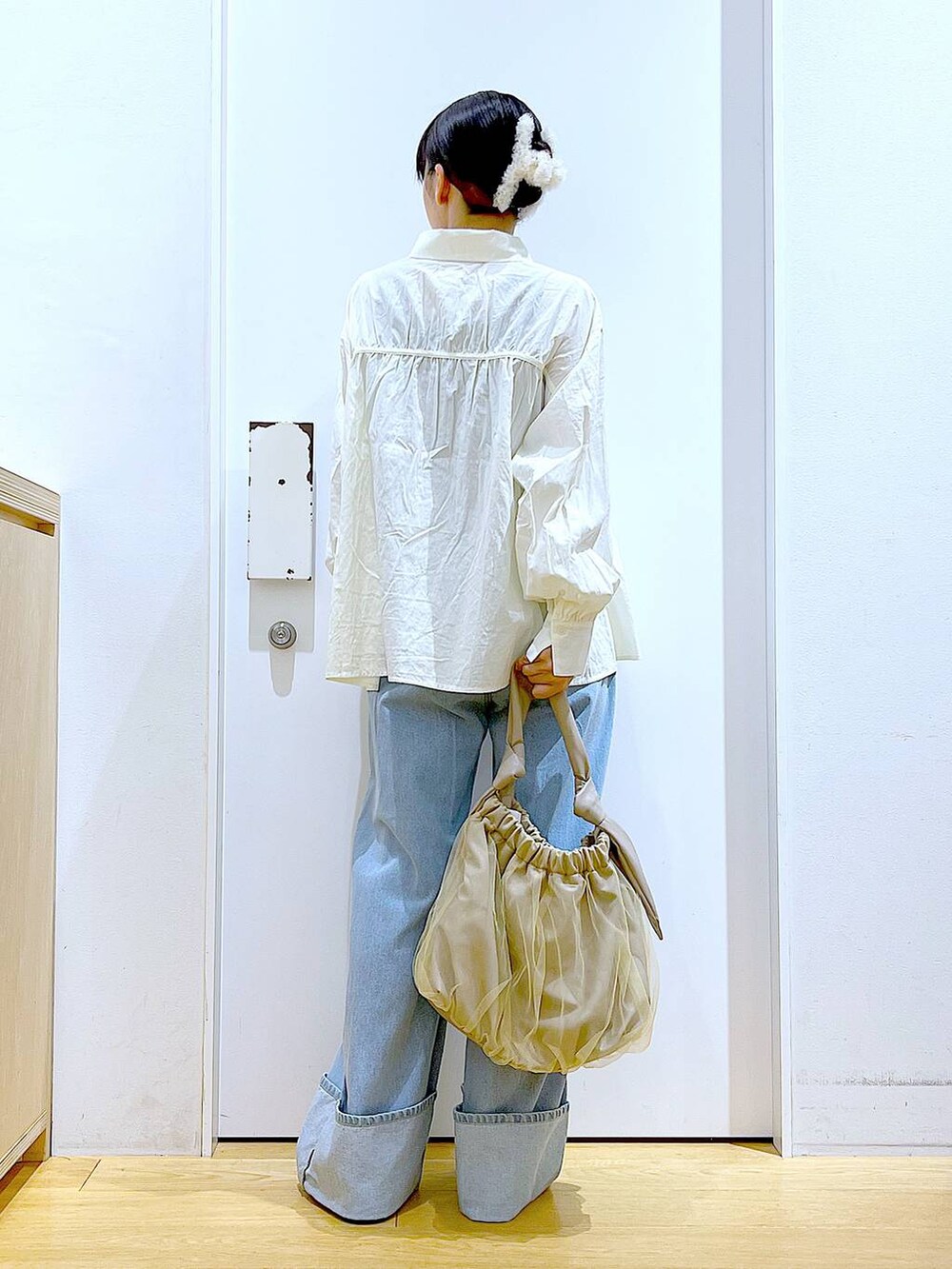 ベージュ系のトートバッグ、シルバー系のローファー、ホワイト系のシャツ/ブラウスを着用したレディースの秋コーディネートの5枚目の写真