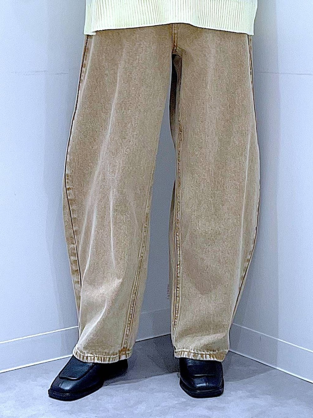 ベージュ系のデニムパンツ、ブラック系のブーツ、ホワイト系のショルダーバッグを着用したレディースの冬コーディネートの8枚目の写真