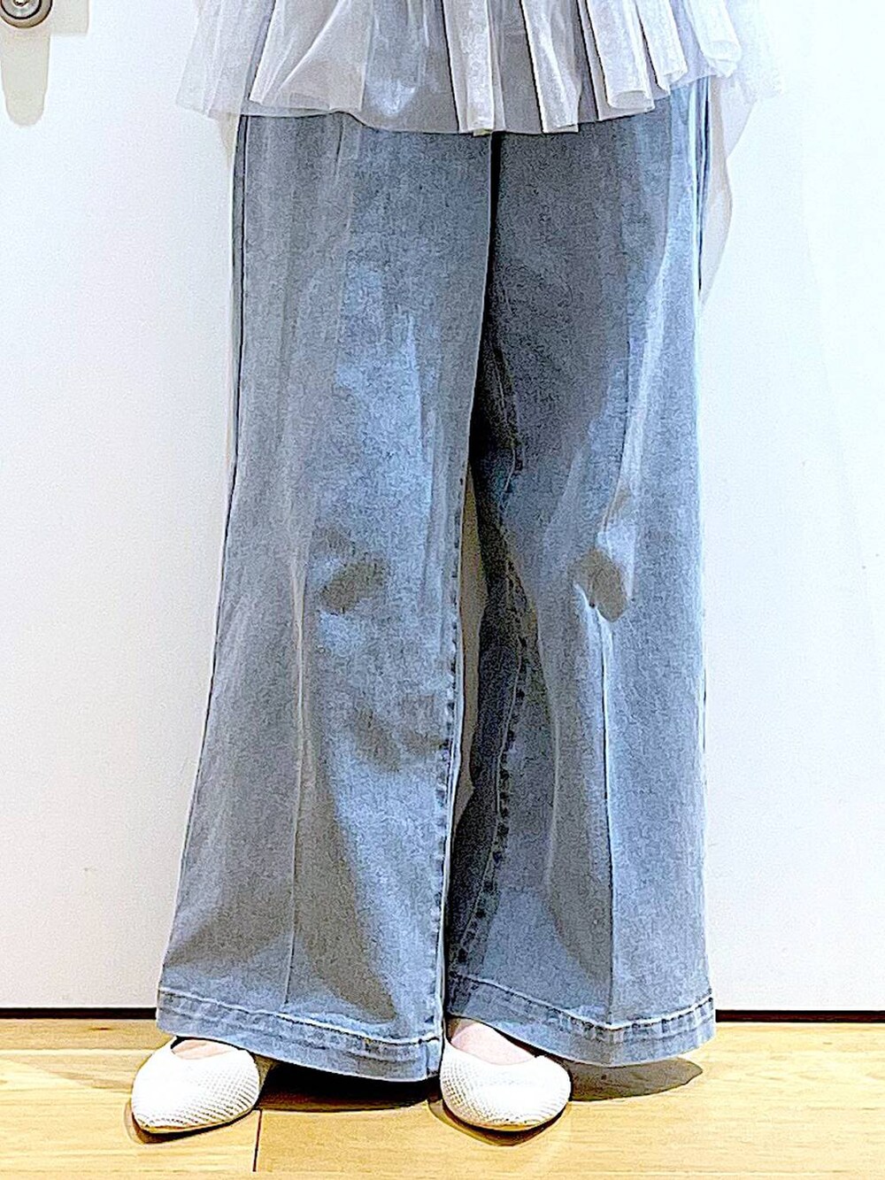 ブルー系のデニムパンツ、ピンク系のショルダーバッグ、ホワイト系のパンプスを着用したレディースの春コーディネートの8枚目の写真