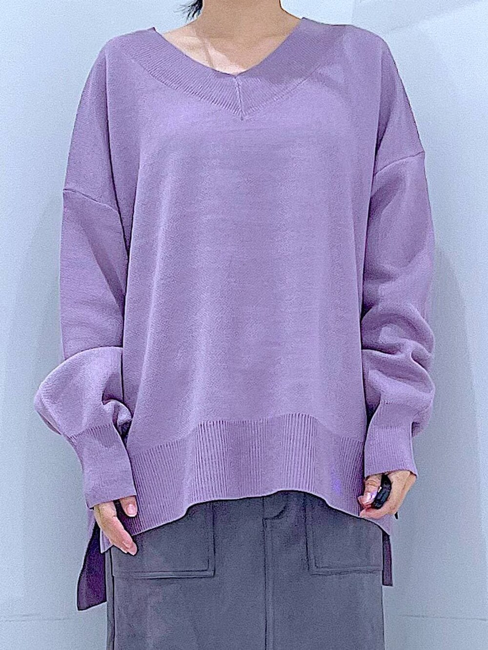 ブラック系のハンドバッグ、ブラック系のブーツ、グレー系のスカートを着用したレディースの冬コーディネートの7枚目の写真