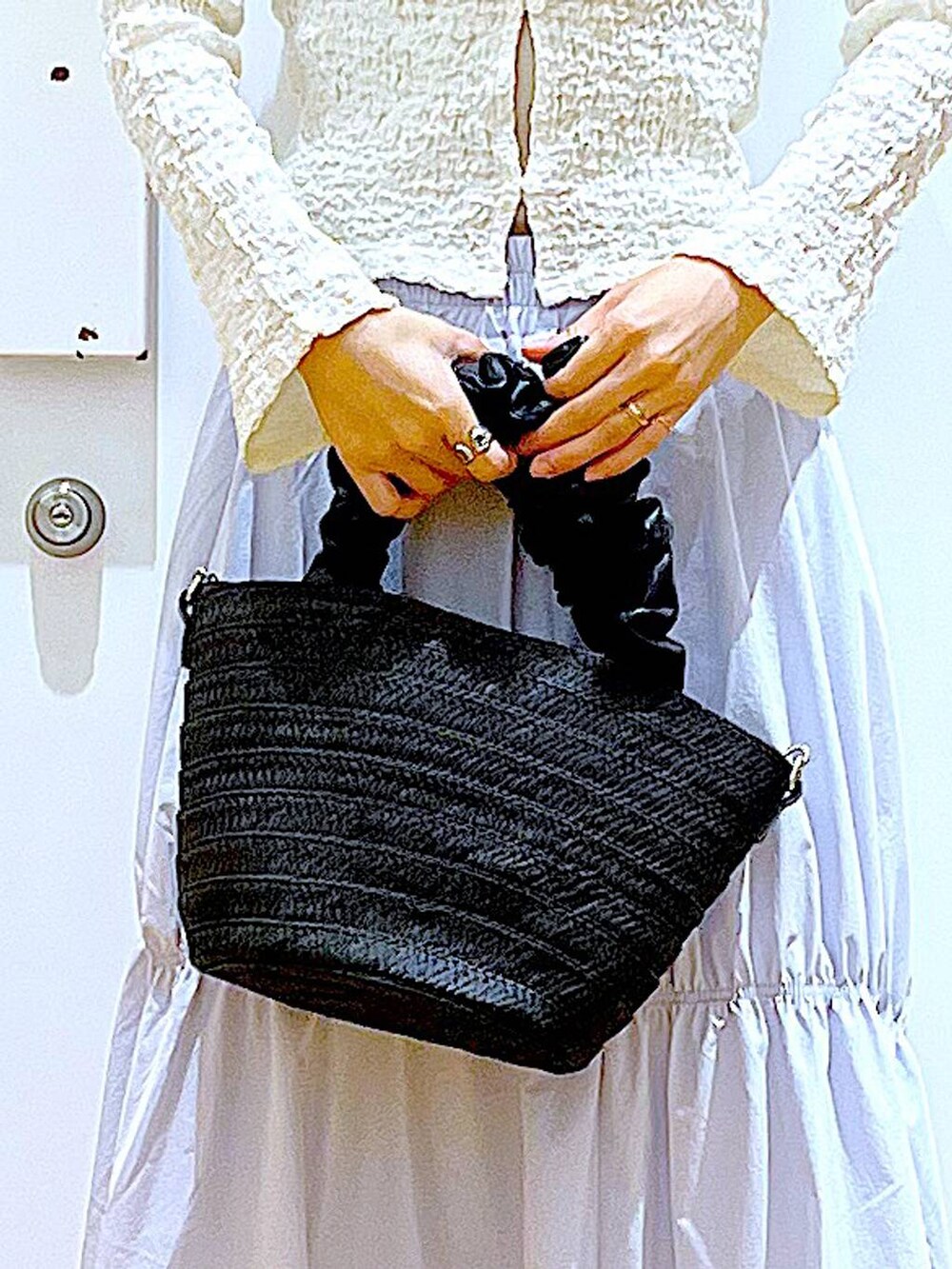 ホワイト系のカーディガン/ボレロ、イエロー系のニット/セーター、ホワイト系のパンプスを着用したレディースの春コーディネートの9枚目の写真