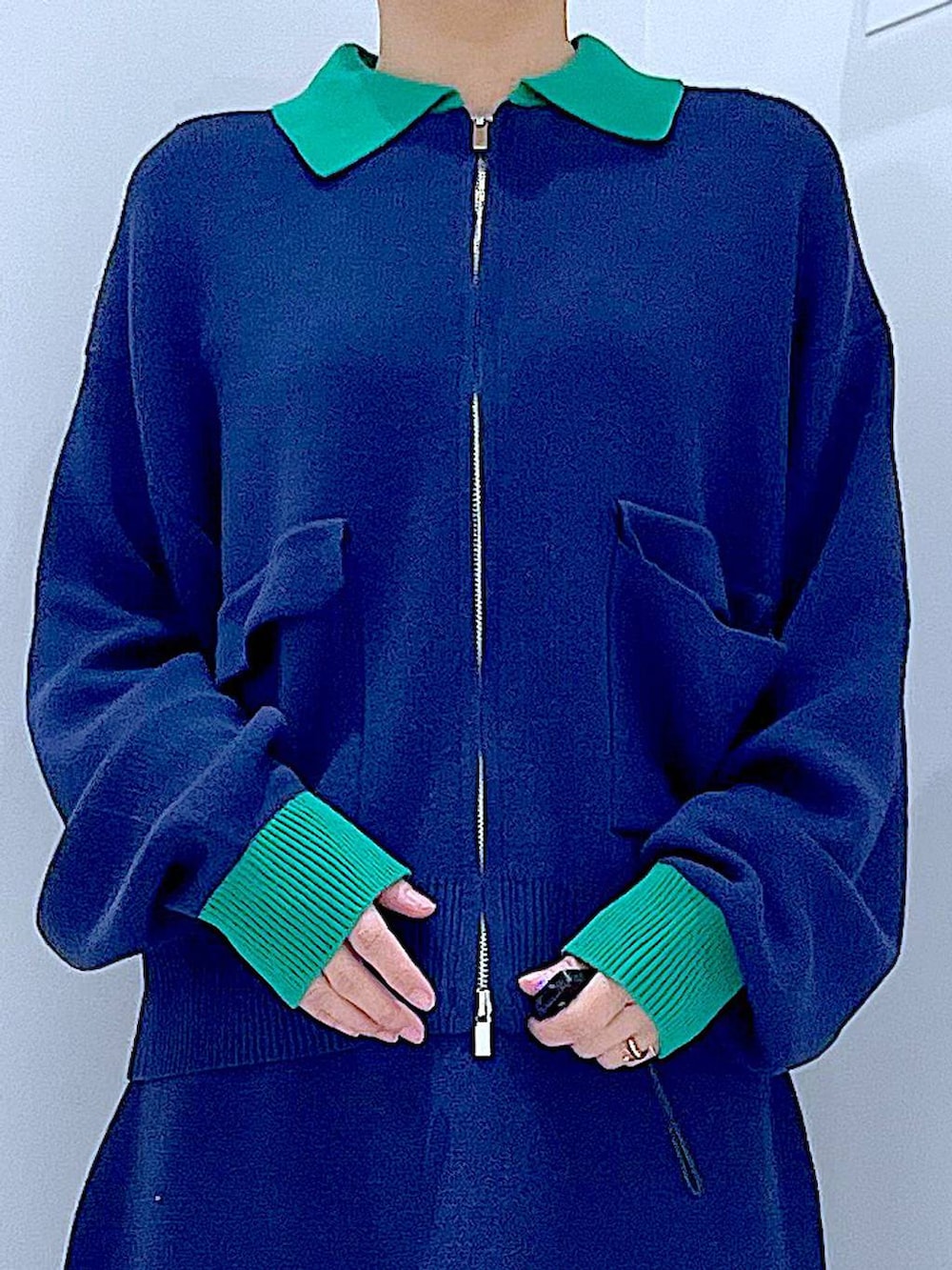 ブラック系のショルダーバッグ、ブラック系のブーツ、ブルー系のスカートを着用したレディースの冬コーディネートの7枚目の写真