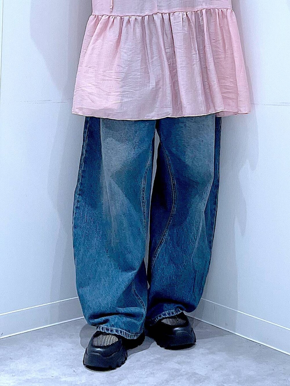 ブルー系のデニムパンツ、ブラック系のスニーカー、ブラック系のショルダーバッグを着用したレディースの春コーディネートの8枚目の写真