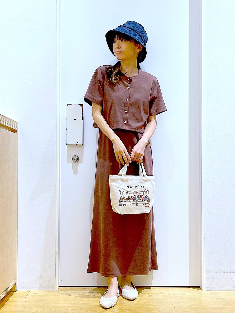 レッド系のワンピース、その他のトートバッグ、ホワイト系のパンプスを着用したレディースの春コーディネートの2枚目の写真