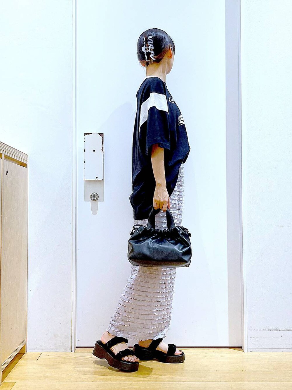 ブラック系のサンダル、ブラック系のショルダーバッグ、ブラック系のTシャツ/カットソーを着用したレディースの夏コーディネートの4枚目の写真