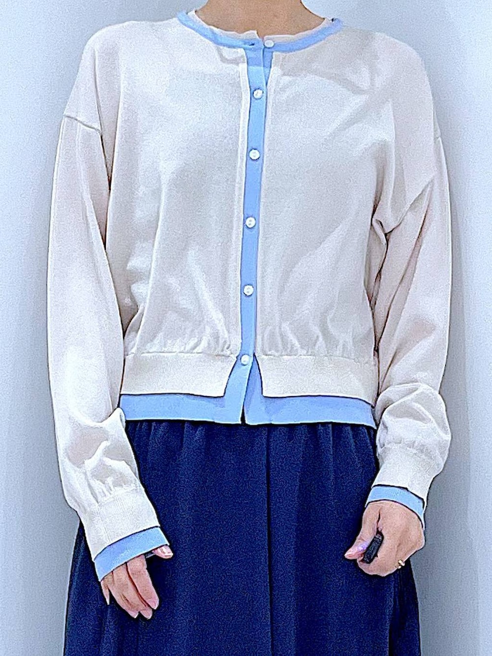 ベージュ系のローファー、ブルー系のスカート、ブルー系のショルダーバッグを着用したレディースの春コーディネートの7枚目の写真