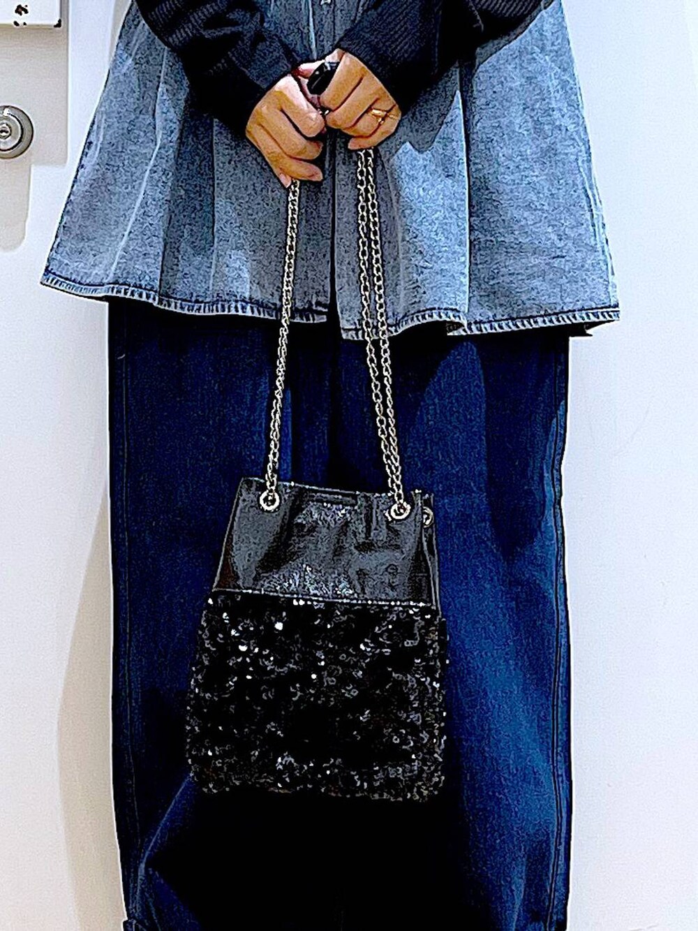 ホワイト系のパンプス、ブルー系のデニムパンツ、ブラック系のショルダーバッグを着用したレディースの春コーディネートの9枚目の写真