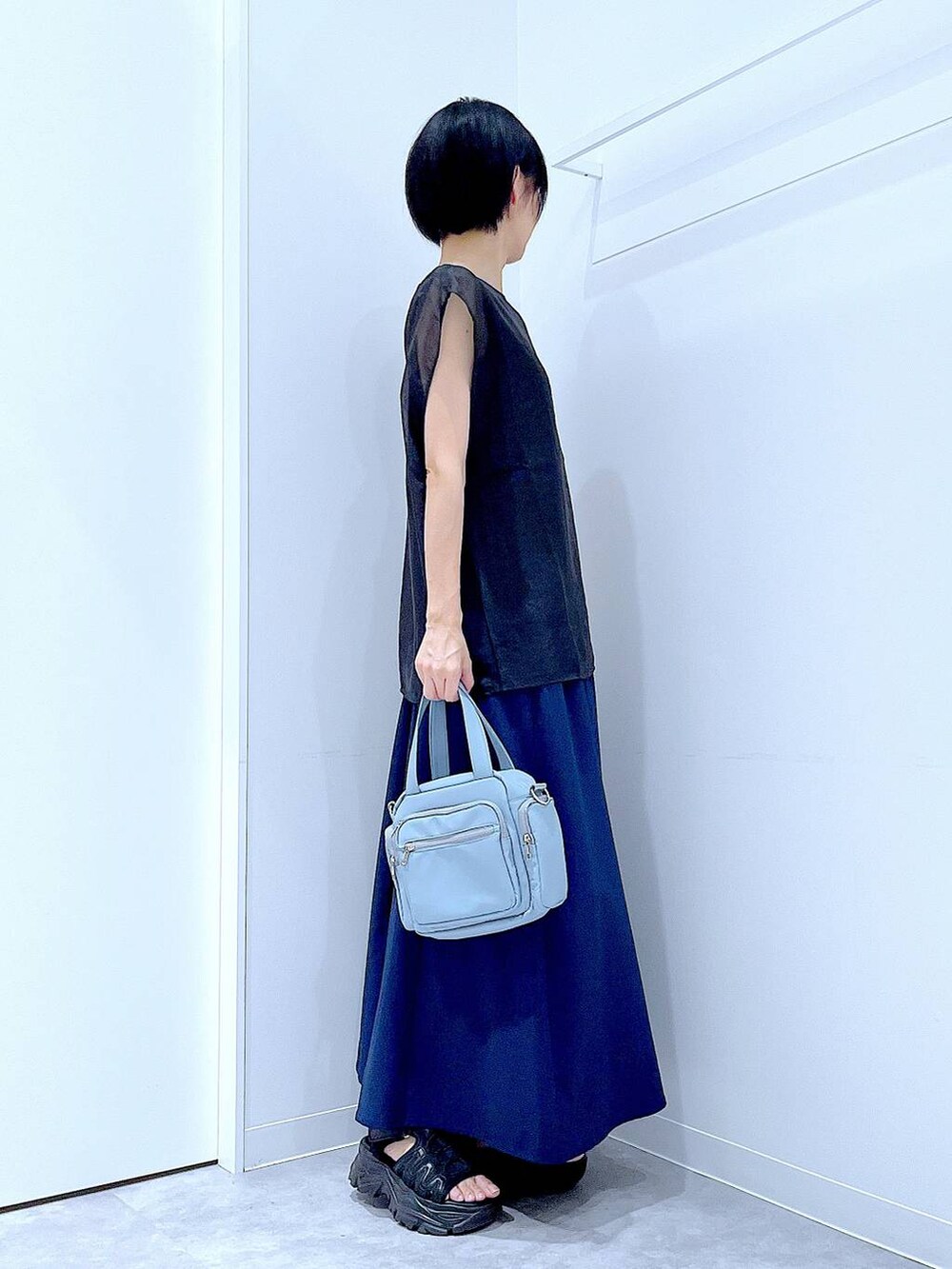 ブラック系のスニーカー、ブルー系のショルダーバッグ、ブルー系のその他パンツを着用したレディースの夏コーディネートの4枚目の写真