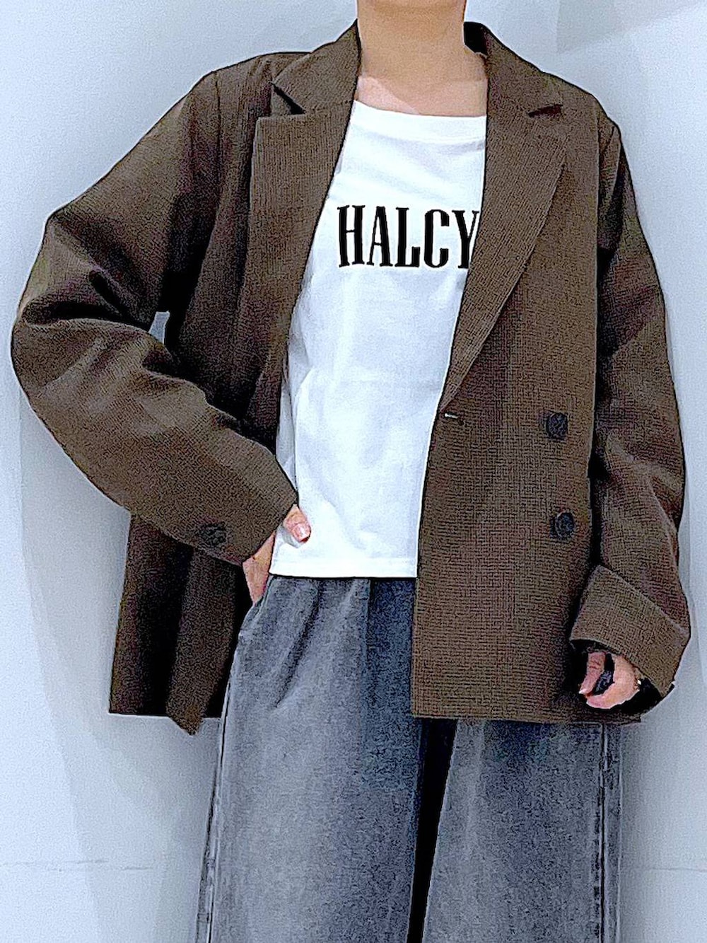 ブラウン系のテーラードジャケット、ブラック系のブーツ、ホワイト系のTシャツ/カットソーを着用したレディースの秋コーディネートの7枚目の写真