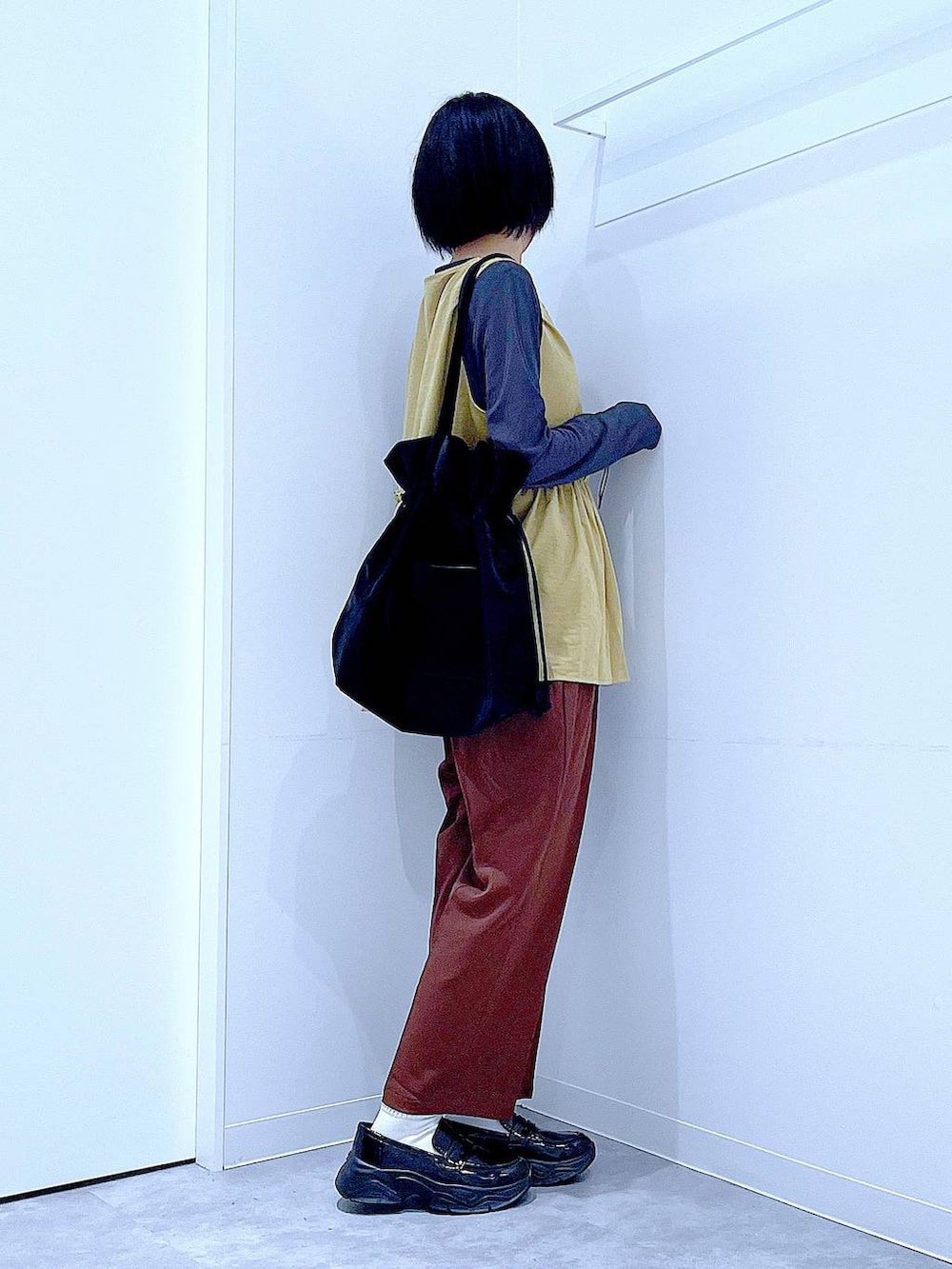 グレー系のTシャツ/カットソー、ブラック系のローファー、ブラック系のトートバッグを着用したレディースの秋コーディネートの4枚目の写真