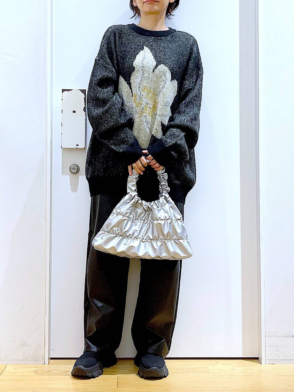 ブラック系のブーツ、ブラック系のその他パンツ、シルバー系のショルダーバッグを着用したレディースの冬コーディネートの6枚目の写真