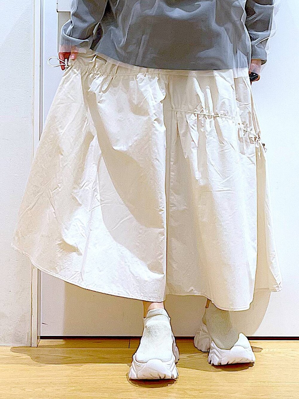 ベージュ系のスニーカー、ホワイト系のその他トップス、ホワイト系のスカートを着用したレディースの春コーディネートの8枚目の写真