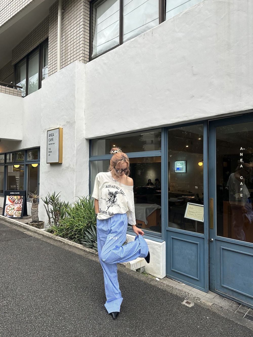 ブルー系のスラックス、ホワイト系のTシャツ/カットソーを着用したレディースの秋コーディネートの2枚目の写真