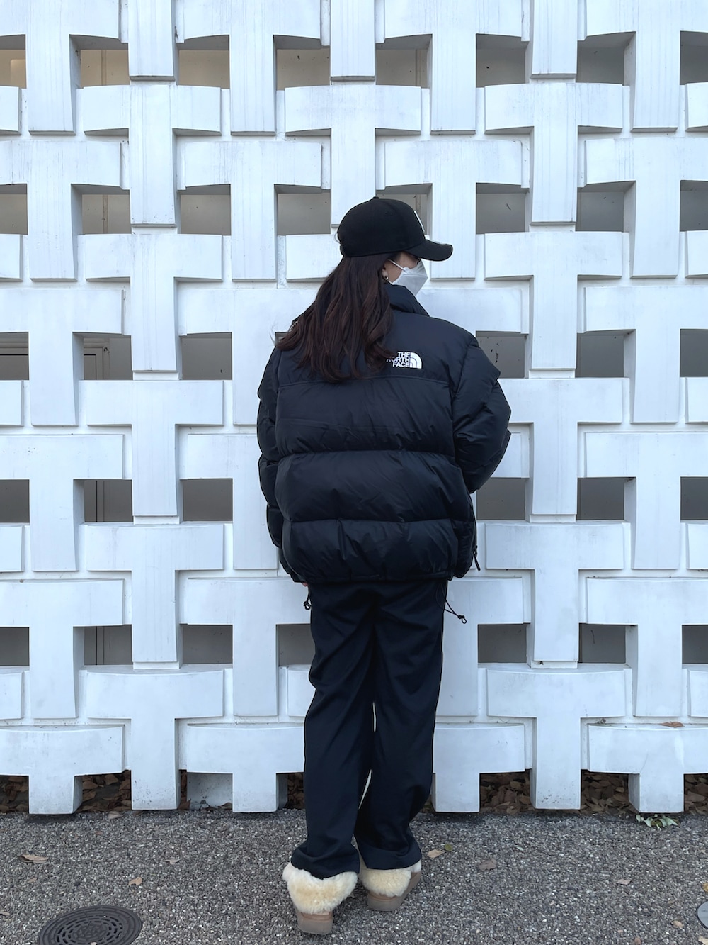 ブラック系のダウンジャケット/コート、ブラック系のスラックス、ブラウン系のブーツを着用したレディースの冬コーディネートの3枚目の写真